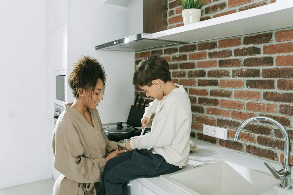 Mother and son working in the kitchen together
